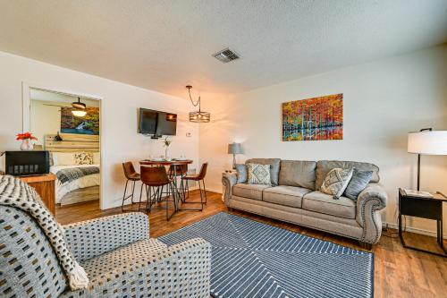 a living room with a couch and a table at Fishing Pond and Pier Secluded Broken Bow Cottage! in Broken Bow