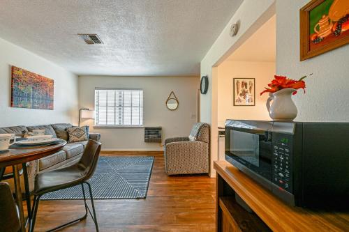 a living room with a couch and a tv at Fishing Pond and Pier Secluded Broken Bow Cottage! in Broken Bow