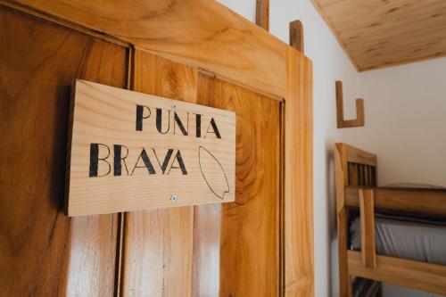 a sign on a door that reads punka braka at La Chamba Surf House in Santa Catalina