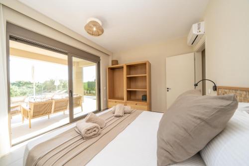 a bedroom with a bed and a large window at Memorial Villa Pessada in Pesádha