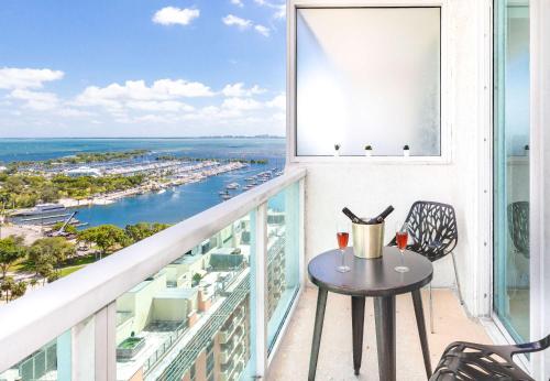 a table on a balcony with a view of the ocean at MVR - Wake to Sunrises Toast to Sunsets in Miami
