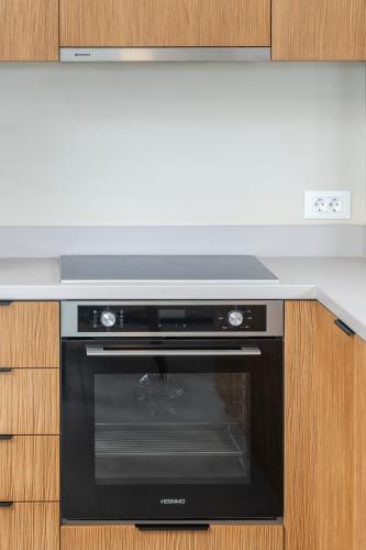 a kitchen with a black oven in a kitchen at Memorial Villa Pessada in Pesádha