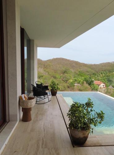 a balcony with a view of a swimming pool at Casa Sirenas - Paradise in Puerto Vallarta in Cruz de Huanacaxtle