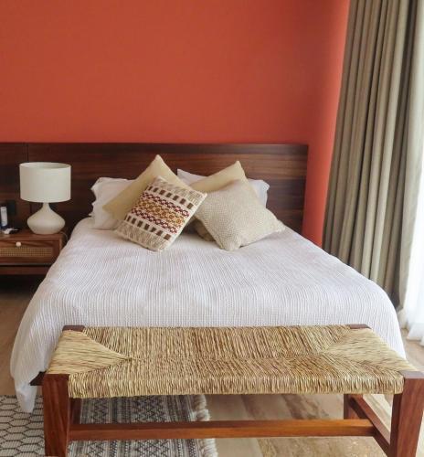 a bed with white sheets and pillows in a bedroom at Casa Sirenas - Paradise in Puerto Vallarta in Cruz de Huanacaxtle