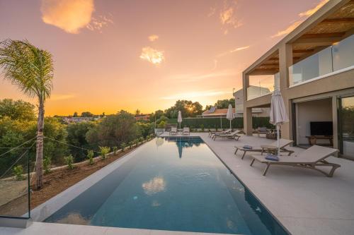a swimming pool in the backyard of a house at Memorial Villa Pessada in Pesádha