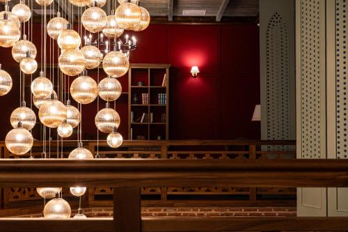 a room with a bunch of lights hanging from the ceiling at AGARANI Estate in Tʼelavi