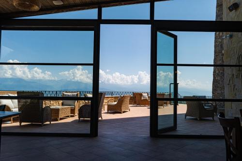 a view of the ocean from a patio with chairs at AGARANI Estate in Tʼelavi