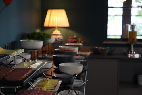 a table topped with bowls and plates of food at AGARANI Estate in Tʼelavi
