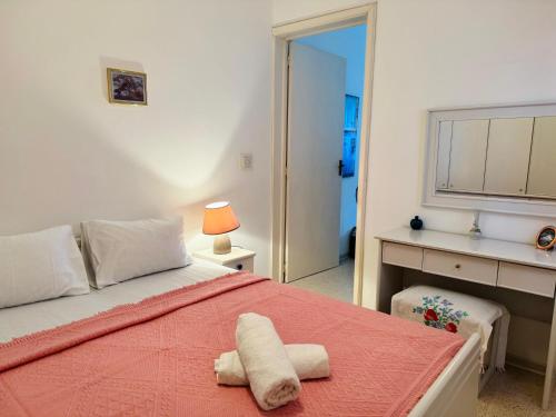 a bedroom with a bed with two towels on it at Gozo House in Marsalforn