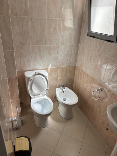 a bathroom with a toilet and a sink at Apartment Albania in Orikum