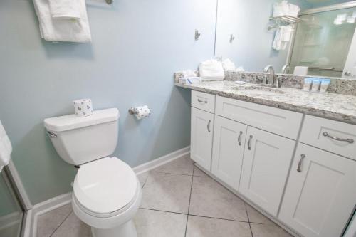a bathroom with a white toilet and a sink at Bright and Beautiful Dunes Room 2nd Floor in Pawleys Island