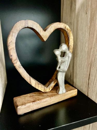 a figurine of a skeleton holding a heart on a shelf at S-HOUSE Avrig Apartament Spațios cu Terasă Privată lângă Sibiu in Avrig