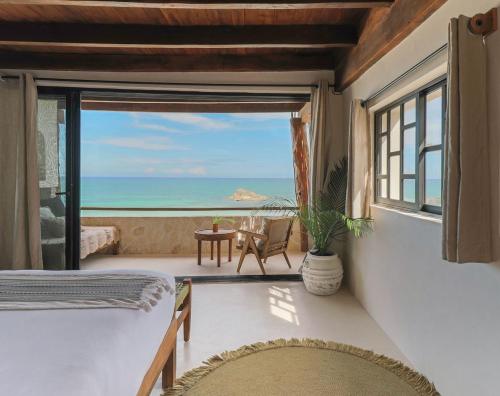 a bedroom with a view of the ocean at Chica in Tulum
