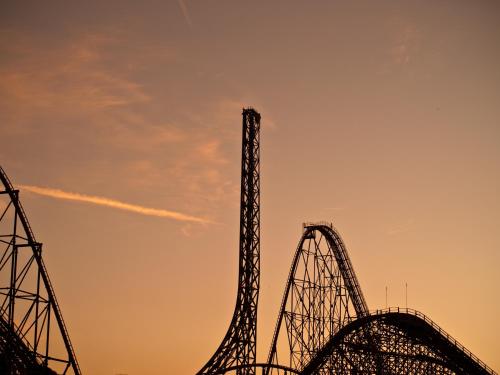 two roller coasters in front of the sunset at ThrillStay Braves & Six Flags Family House in Lithia Springs