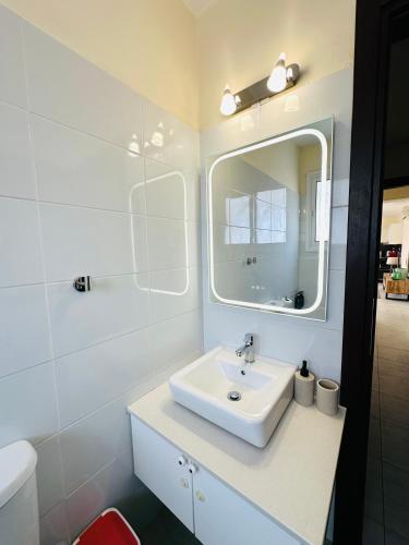 a bathroom with a sink and a mirror at Serene Getaway Near Protaras in Paralimni
