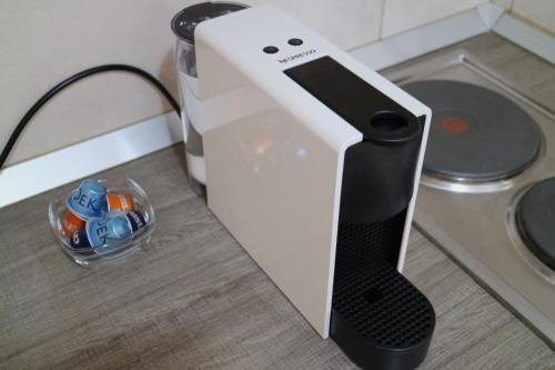 a white toaster sitting on a counter with a bowl of pills at Studio Apartments & Rooms Lela, Sipan island in Šipanska Luka