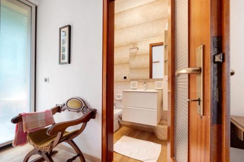 a room with a chair and a bathroom at Casa Edda in Brenzone sul Garda