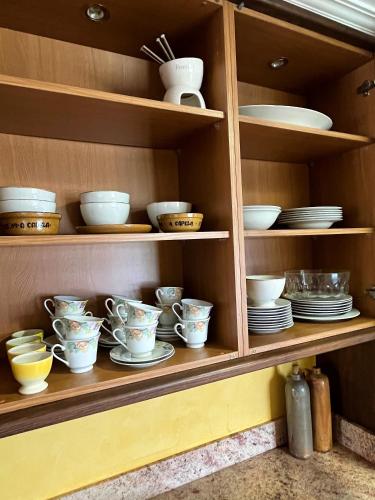 a cabinet filled with dishes and bowls and plates at Casa María B in Santa Eulalia