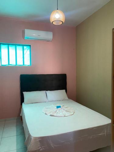 a bedroom with a bed with a white blanket on it at LM Flats - Beach Park Porto das Dunas in Aquiraz