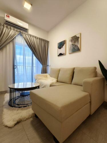 a living room with a couch and a table at Sunsuria Luxury Muji 3BR suit for 6-8px in Shah Alam