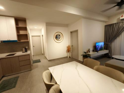 a kitchen and a living room with a table and chairs at Sunsuria Luxury Muji 3BR suit for 6-8px in Shah Alam