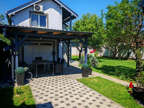 a house with awning and a patio at Apartman - sobe Corina-blizu Osijeka in Bilje
