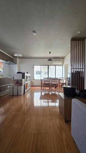 a large living room with a kitchen and a dining room at 海の風 in Wakayama