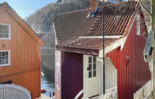 a couple of red buildings with a body of water at 2 Bedroom Cozy Home In Arendal in Arendal