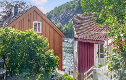 two red buildings next to a body of water at 2 Bedroom Cozy Home In Arendal in Arendal