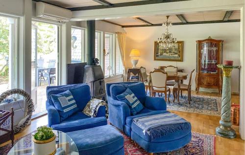 a living room with two blue chairs and a table at Nice Home In Vittsjö With Wifi in Vittsjö