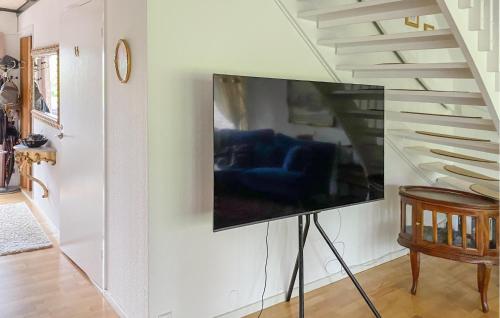 a flat screen tv hanging on a wall in a living room at Nice Home In Vittsjö With Wifi in Vittsjö