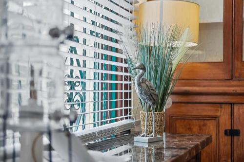 a vase with a bird sitting on a table at 4 Bed Park View House-Free Parking - Sleep 8 in Plymouth