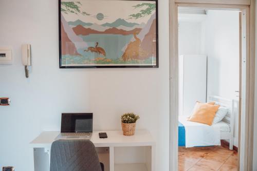 a room with a desk and a laptop on a table at Manfredi Apartments in Torre Annunziata