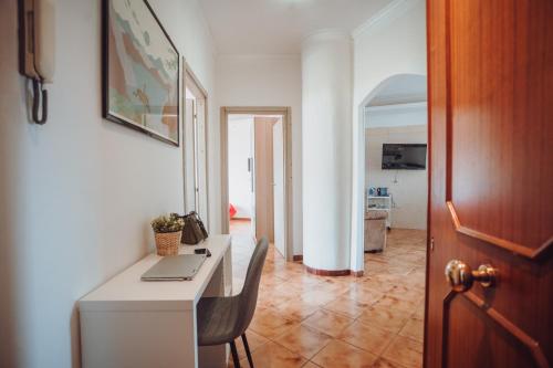 a room with a desk with a laptop on it at Manfredi Apartments in Torre Annunziata
