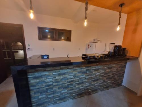 a kitchen with a brick counter top in a room at Falésias de Pipa - Apto 205 in Pipa