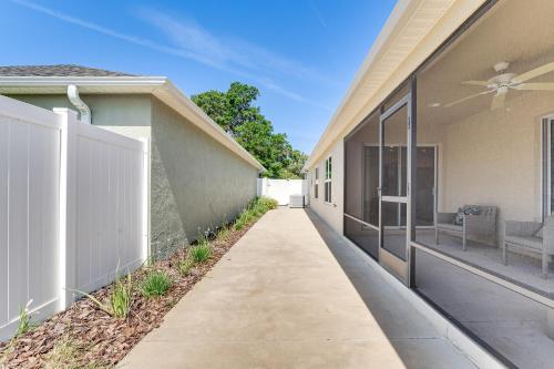 a walkway between two buildings with a fence at Less Than 1 Mi to Brownwood Paddock Square Home with Patio! in The Villages