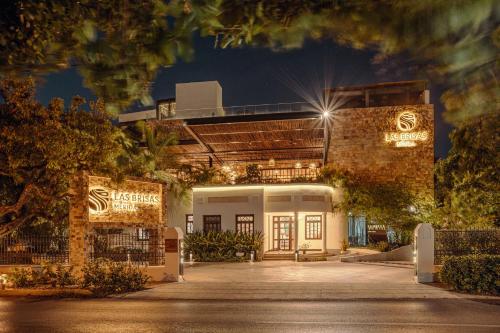 a building with lights on it at night at Hotel Las Brisas Merida in Mérida