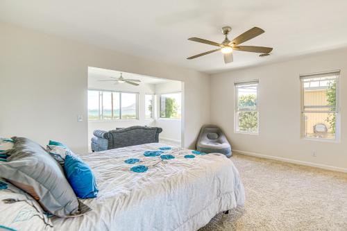 a bedroom with a bed and a ceiling fan at Steps to Clear Lake Hot Tub Haven in NorCal! in Lakeport