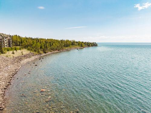 a view of the shore of a large body of water at Breathtaking Lake Views 1BR King Suite, Kitchen & Heated Pools in Two Harbors
