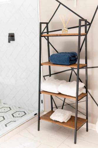 a shelf in a bathroom with towels at A Cabin in the City with a 5 Star Lush Backyard in Atlanta