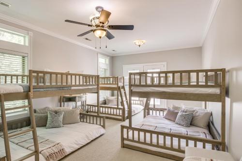 a room with three bunk beds and a ceiling fan at Dock and Home Theater Pet-Friendly Lake Wylie Home in Fort Mill