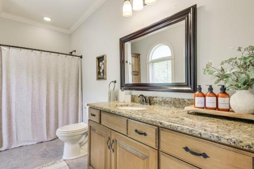 a bathroom with a sink and a toilet and a mirror at Dock and Home Theater Pet-Friendly Lake Wylie Home in Fort Mill