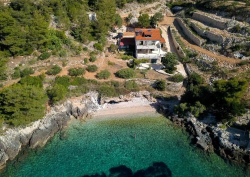 an aerial view of a house next to a beach at Family friendly seaside apartments Cove Rapak, Hvar - 12779 in Gdinj