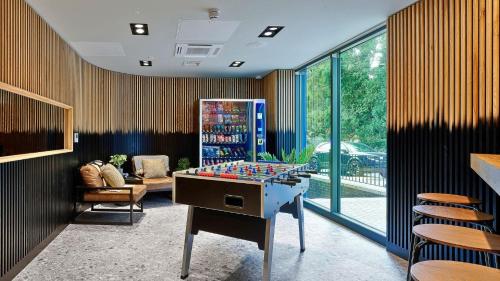 a room with a foosball table in the middle at For Student Only - The Helix in Wembley in London
