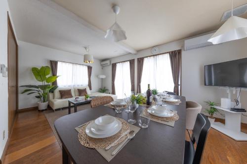 a dining room and living room with a dining table at higashibori five in Niigata