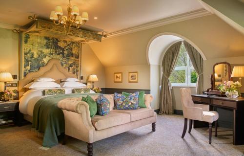 a bedroom with a bed and a chair and a desk at The Killarney Park in Killarney