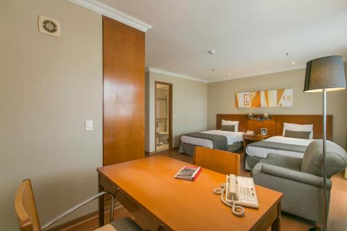 Postel nebo postele na pokoji v ubytování Plaza Rio Residences - Barra First