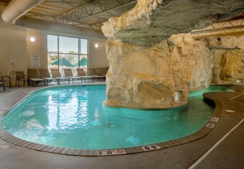 a large swimming pool with a rock wall at Holiday Inn & Suites Virginia Beach - North Beach by IHG in Virginia Beach