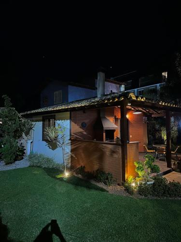 a house with lights on the yard at night at Cabana Zailu in Petrópolis