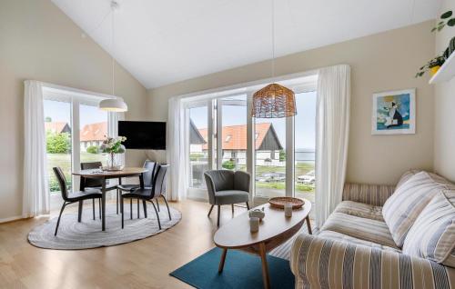 a living room with a couch and a table at 2 Bedroom Awesome Home In Gudhjem in Gudhjem